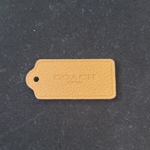 Coach: Tan Pebbled Leather Bag Tag without chain